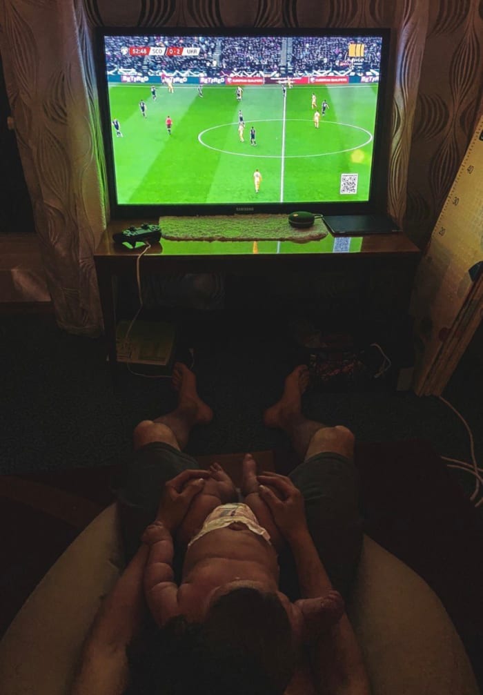 Vyshkvarok (left) and a friend were able to watch the first half at a bar, but most Ukrainian viewers hunkered down at home, like Dmytro Kabanets and his daughter Emily.
